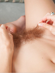 Dennie strips on the couch baring her petite body and unshaven pussy. - Erotic and nude pussy pics at GirlSoftcore.com