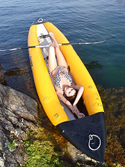 Wonderful long haired girl taking off swimsuit and showing shaved pussy in a yellow boat. - Erotic and nude pussy pics at GirlSoftcore.com