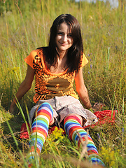 Wonderful teen beauty in long striped socks taking off her clothes outdoors in the field. - Erotic and nude pussy pics at GirlSoftcore.com