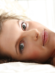 Beautiful teen honey with tempting body and alluring glance posing absolutely naked on bed. - Erotic and nude pussy pics at GirlSoftcore.com