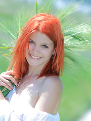 Surrounded by vast green grass, Violla\'s alluring beauty and charmingg allure stands out, with her pale smooth skin, fiery red hair, pink, perky boobs, and delectable labia. - Erotic and nude pussy pics at GirlSoftcore.com