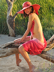 Enchanting girl in a hat with a wide brim showing her perfect body outdoor on the coast. - Erotic and nude pussy pics at GirlSoftcore.com