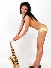 Janice in panties playing the saxophone topless - Erotic and nude pussy pics at GirlSoftcore.com
