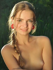 Bridgit playfully strips her beautiful dress and poses sensually all over the sand. - Erotic and nude pussy pics at GirlSoftcore.com