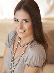 Csilla smiles sweetly as she strips off her clothes on top of the sofa - Erotic and nude pussy pics at GirlSoftcore.com