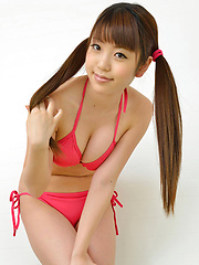 Mizuho Shiraishi with cans in pink bath suit plays with her hair - Erotic and nude pussy pics at GirlSoftcore.com