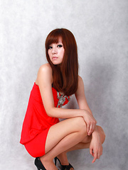 Sandy Asian on heels shows hot behind in red dress for pictures - Erotic and nude pussy pics at GirlSoftcore.com