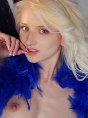 White thigh-high stockings and bright blue slingback peep toe pumps accentuates Nika N\'s sexy long legs as she poses seductively for the camera with a blue feather boa wrapped around her body. - Erotic and nude pussy pics at GirlSoftcore.com